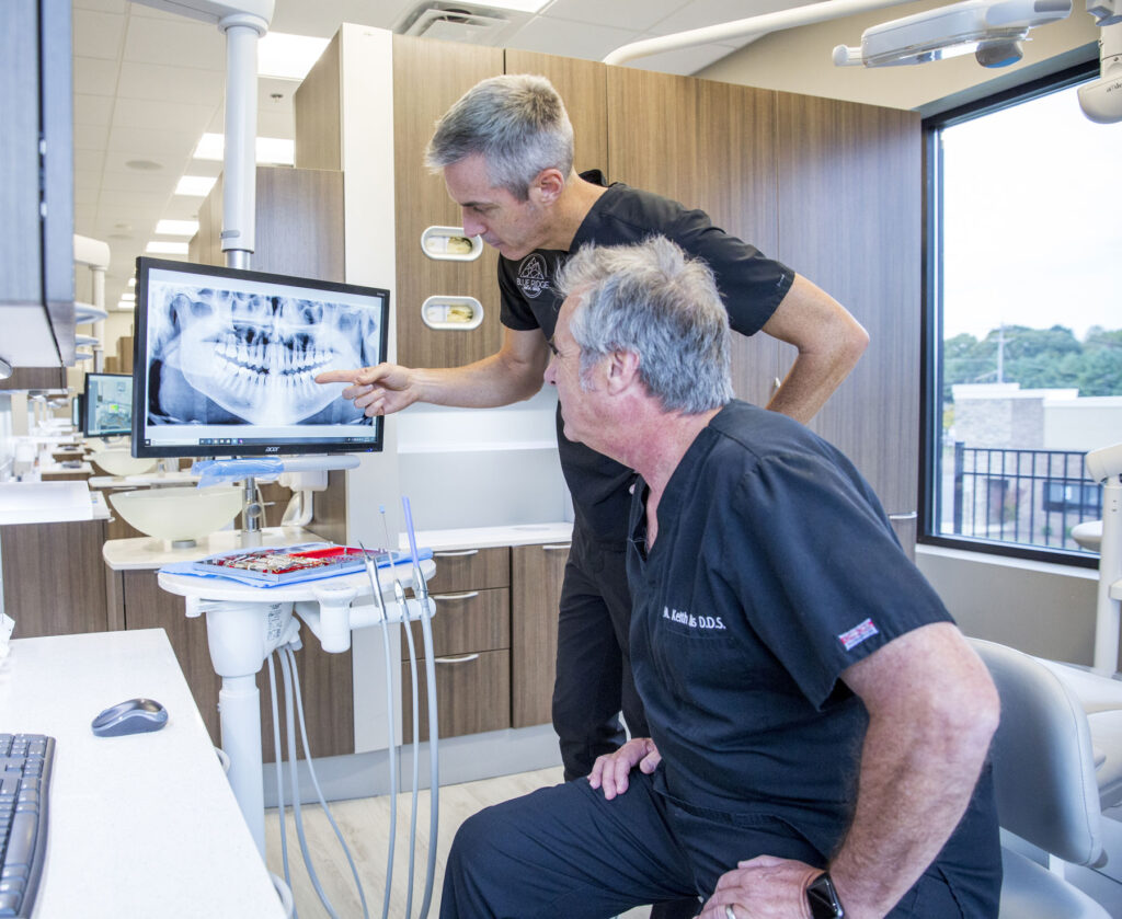 2 dentists reviewing an xray before dental veneers